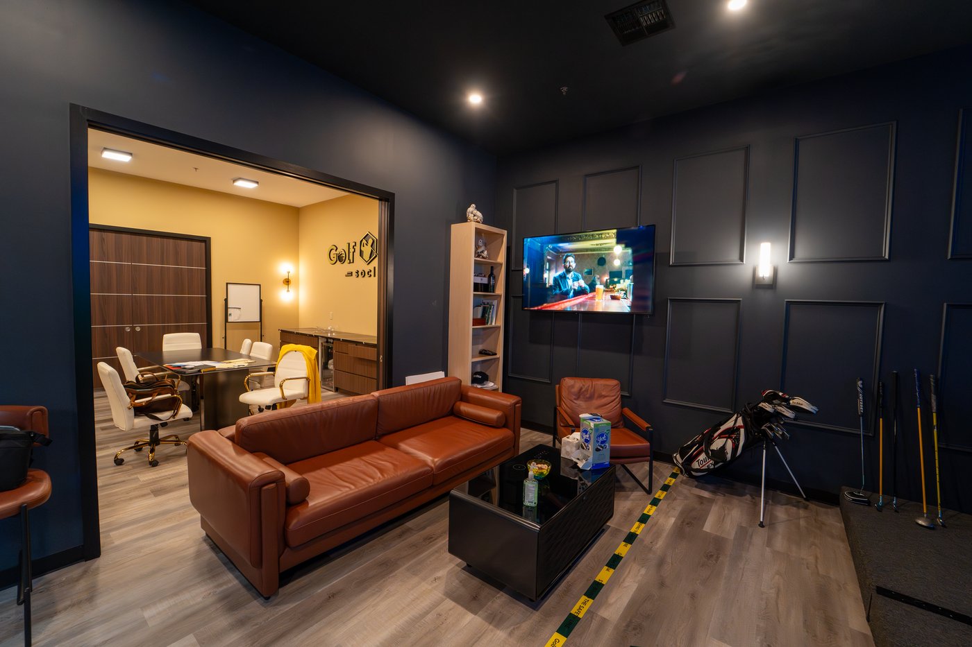 GolfCube Social lounge with leather couches and TV