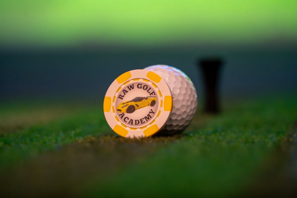RAW Golf Academy branded ball marker and golf ball