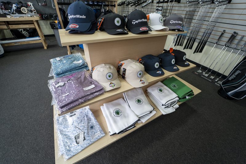 Pro shop — hats, polos, and towels display